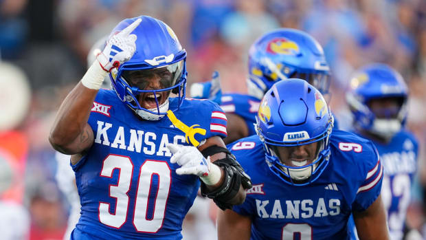 Sep 1, 2023; Lawrence, Kansas, USA; Kansas Jayhawks linebacker Rich Miller (30) and defensive lineman Austin Booker (9) celebrate after a play during the first half against the Missouri State Bearsa at David Booth Kansas Memorial Stadium. Mandatory Credit: Jay Biggerstaff-USA TODAY Sports  